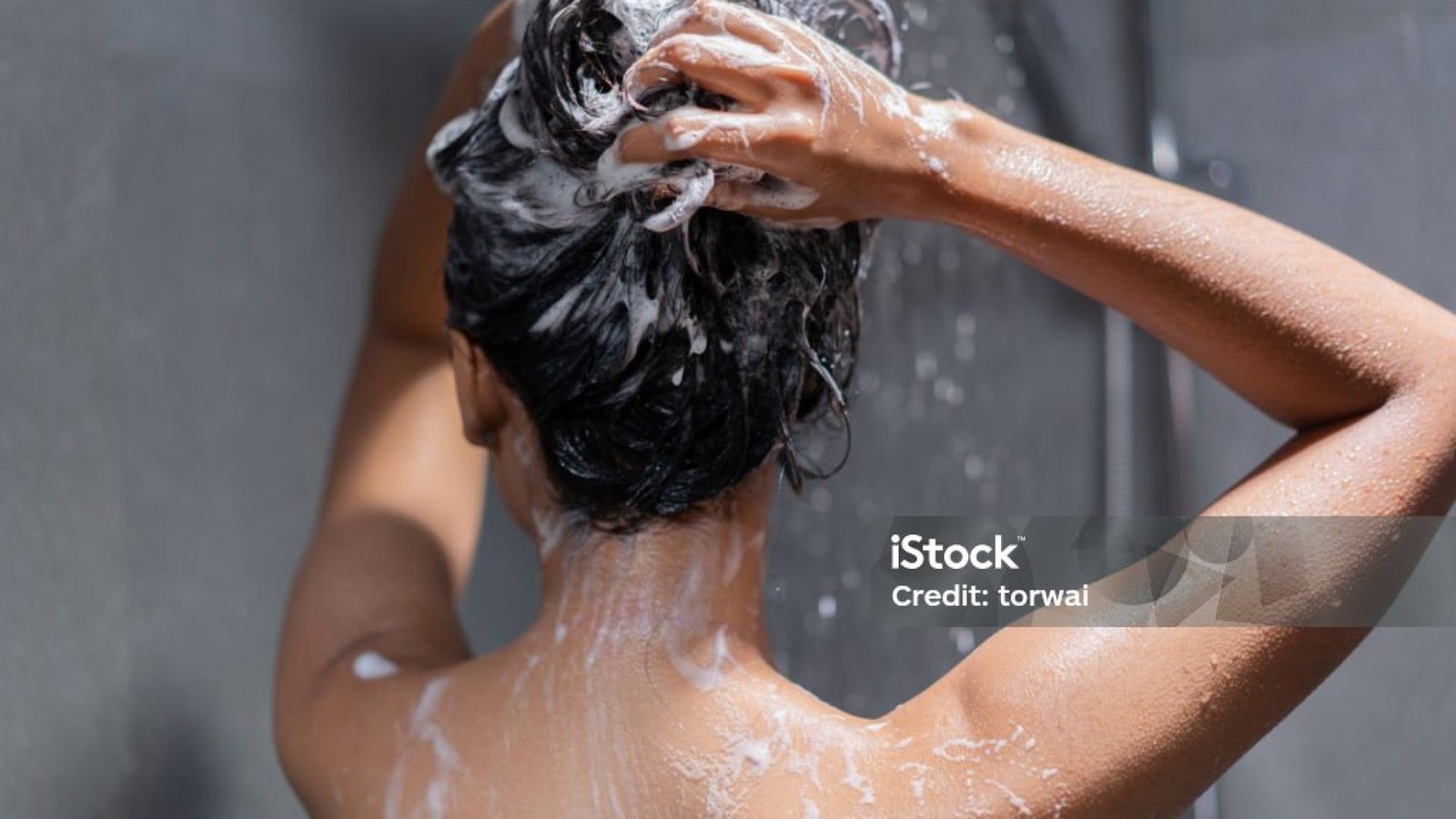 Woman bathing and washing her hair relaxed.